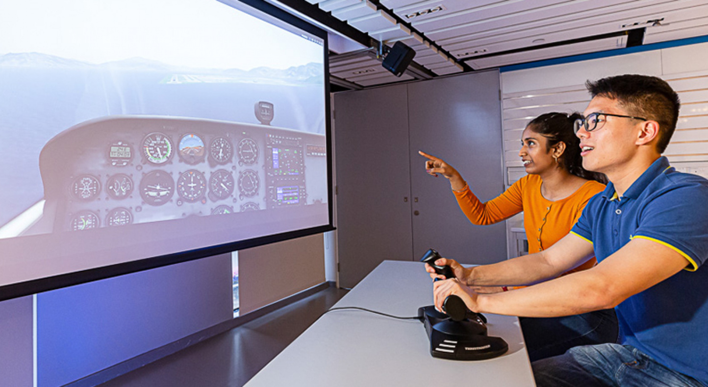 Students engaging in a flight simulator